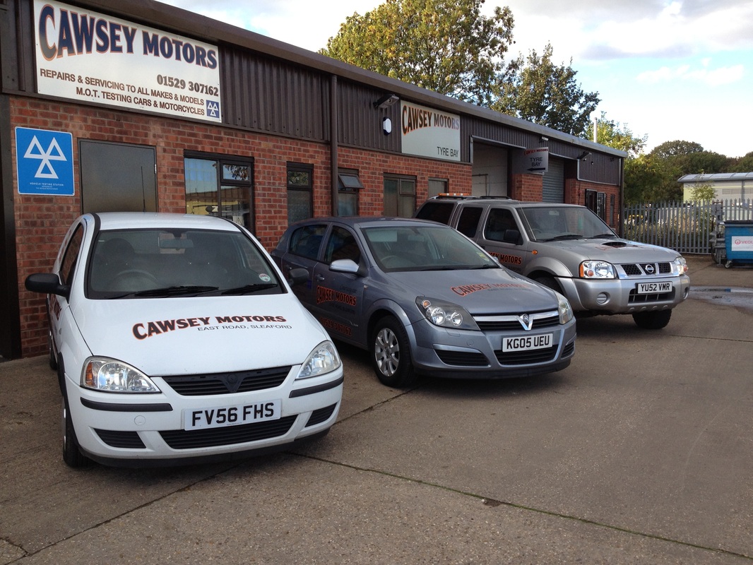 The Cawsey Motors workshop and MOT centre on East Road, Sleaford, with liveried Cawsey Motors vehicles outside